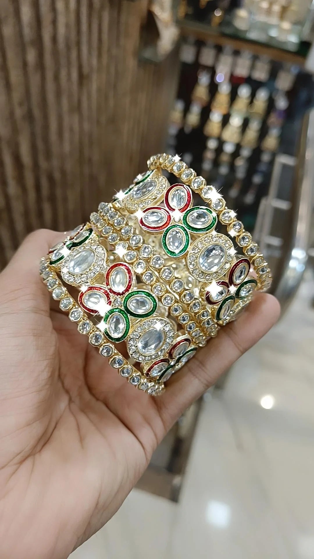 Gold Kundan Bangles with Red-Green Crystal Accents and Stone Detailing