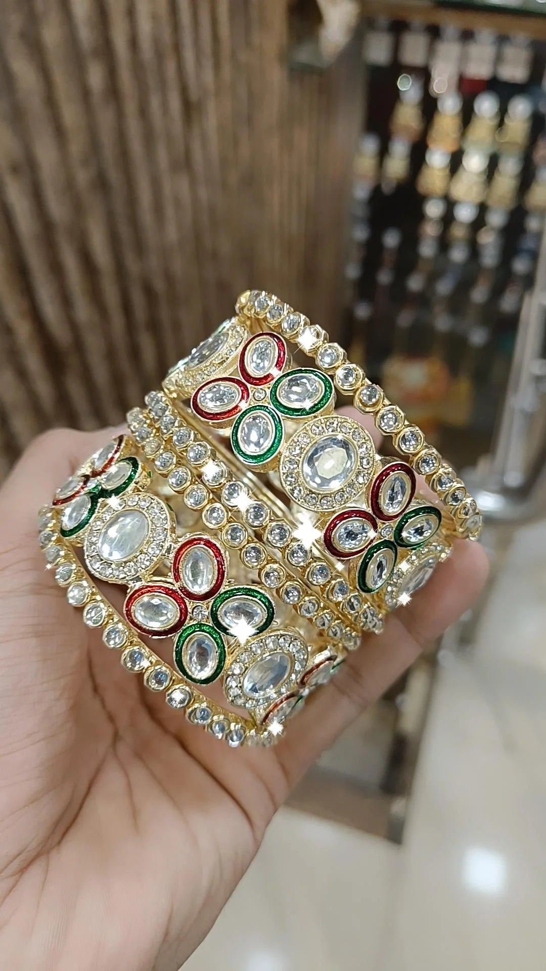 Gold Kundan Bangles with Red-Green Crystal Accents and Stone Detailing