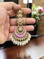 Graceful pink and gold-plated kundan maang tikka adorned with pearls, perfect for bridal and festive looks