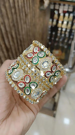 Gold Kundan Bangles with Red-Green Crystal Accents and Stone Detailing